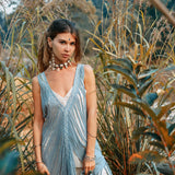 This sleeveless and lightweight dress features an open "V" side cut and beautiful hand-looped tassel edging.