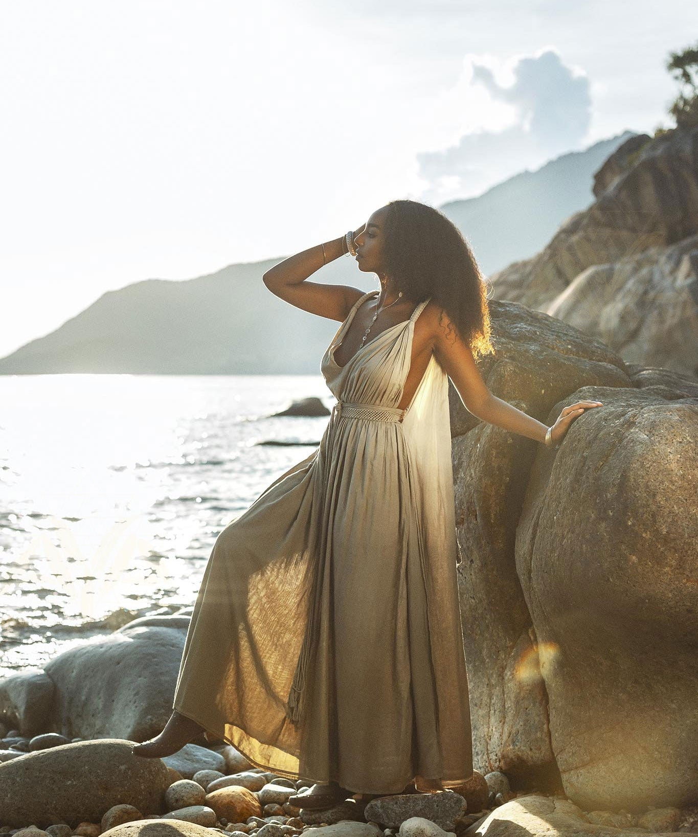 A dark green dress with a flowing silhouette, inspired by Greek goddesses