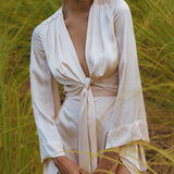 Stylish Powder Pink Venus Peace Silk Skirt, featuring a minimalist wrap design perfect for summer. This organic wrap skirt combines elegance and comfort, ideal for casual outings or special occasions.