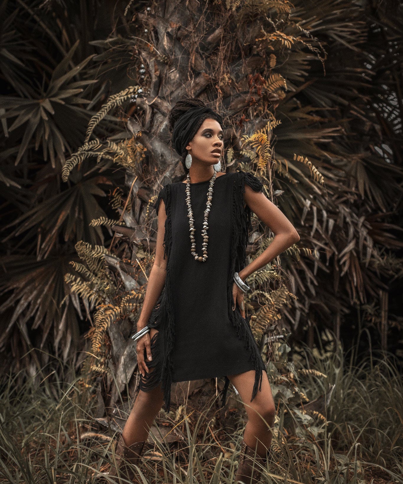 This black mini dress is perfect for a boho-chic look with its open sides and ladders.