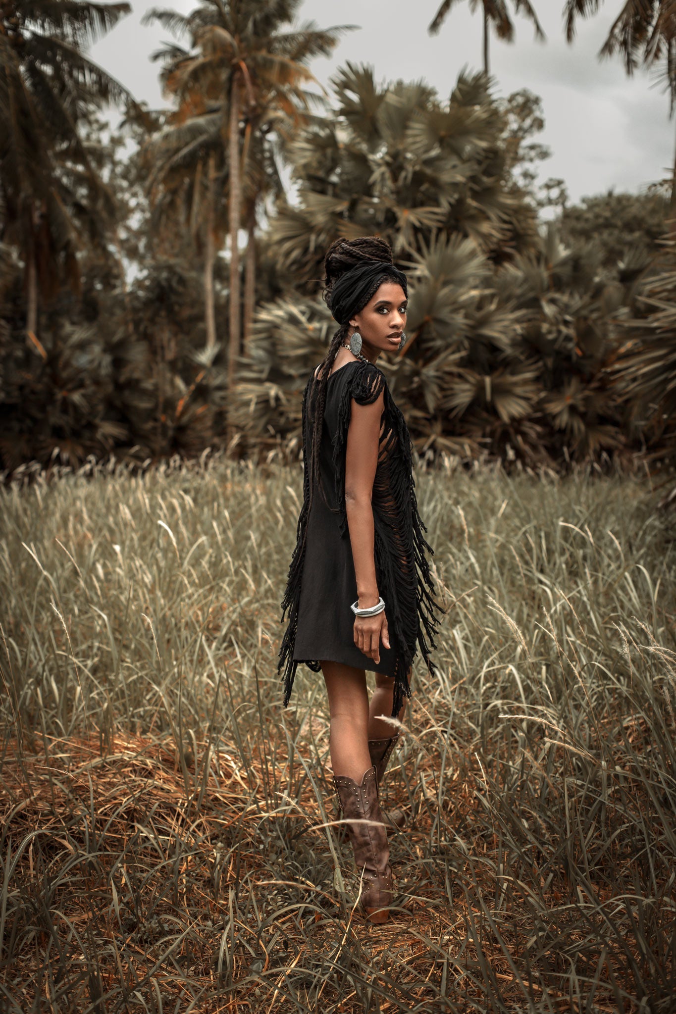 A boho-chic classic, this black mini dress features open sides and ladders.