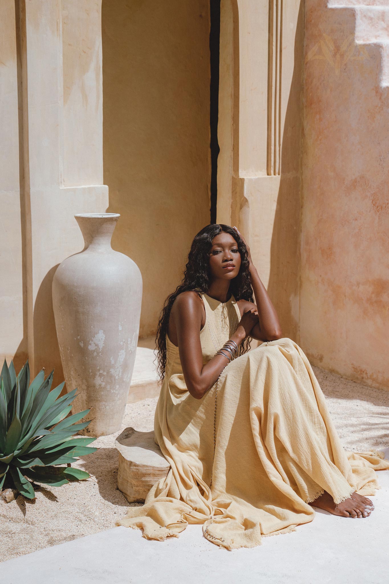 Flowy Gold Goddess Dress adorned with small jingle bells; inspired by Indian beliefs. Hand-embroidered by local artisans and colored with organic ombré dyes.