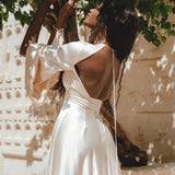Radiate elegance in this exquisite off-white peace silk maxi dress, boasting a bohemian flair with its enchanting bell sleeves and eye-catching open back.